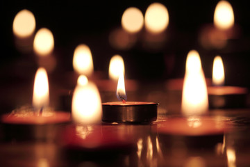 Candles light select focus, black background.