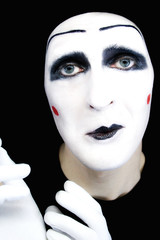 Portrait of  sad mime in white gloves