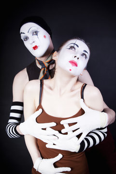 Couple embracing mimes