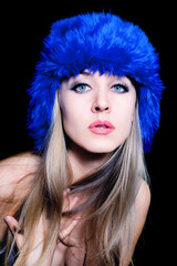 Fototapeta premium beautiful young woman in blue winter hat