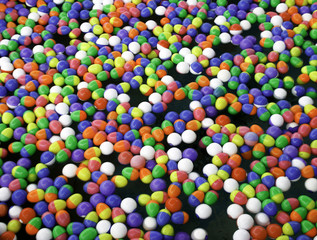 Colorful plastic eggs toys floating on the water background