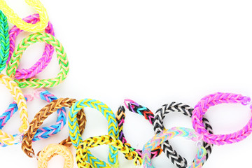 Colorful rubber band bracelets on white background