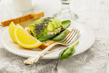 Sandwich of the pair slices  fresh white bread toast with spinach, chicken, dressing