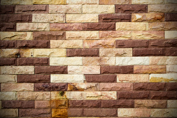 dark brown stone brick wall background, vignette