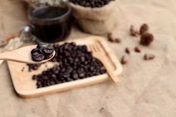Fototapeta na wymiar Roasted coffee beans with hot coffee