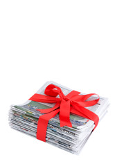 Newspaper stack with red bow