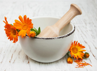 flower of calendula officinalis in mortar
