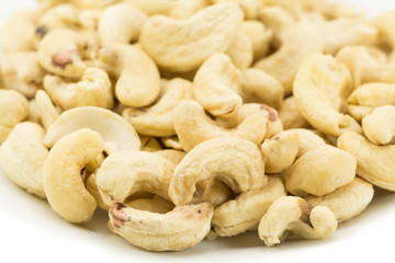 Cashew nuts on a rustic wooden against  wood background