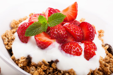 Fresh strawberries , yogurt and homemade granola