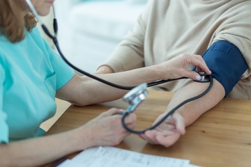 Medic measuring blood pressure