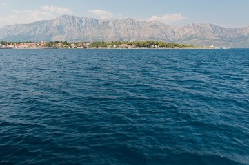 Fototapeta premium Town Sucuraj on south end of island Hvar in Adriatic sea with mountain Biokovo in background. Croatia