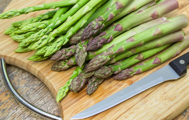 fresh asparagus on a cutting Board