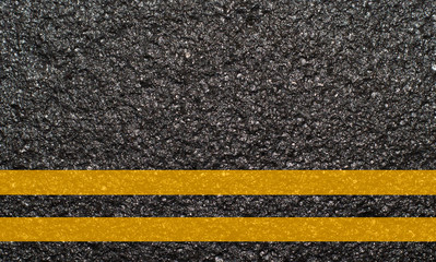 Double yellow line on asphalt texture