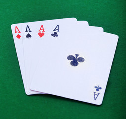 Four aces french card on green table