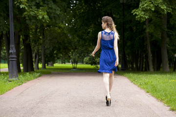 Beautiful young blonde woman in blue dress