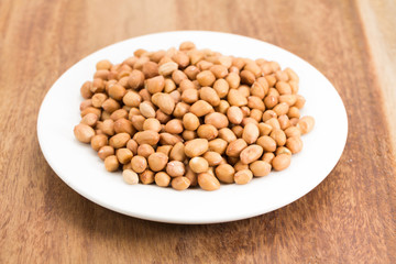 peanuts without shell on wooden background