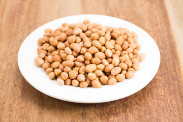 peanuts without shell on wooden background