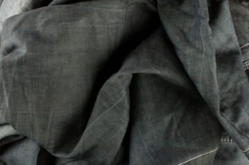 Artistic folded black jeans fabric