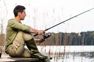Foto auf Acrylglas Angeln Man relaxing fishing or angling at lake
