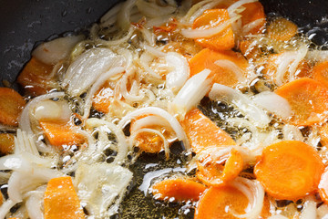 Onions and carrots in the pan.
