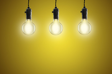 Idea concept - Vintage incandescent bulbs on yellow background
