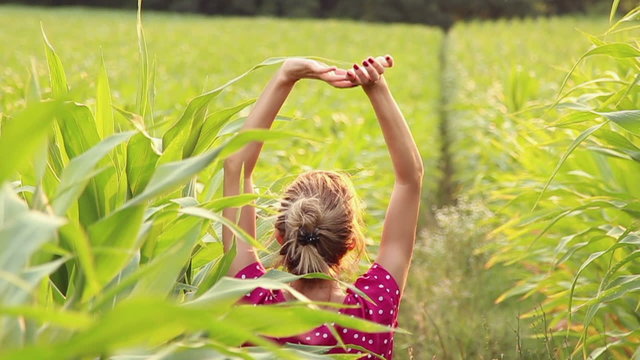 Girl relaxing in a corn field.