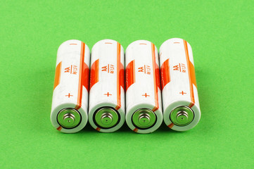 AA batteries isolated on the green background