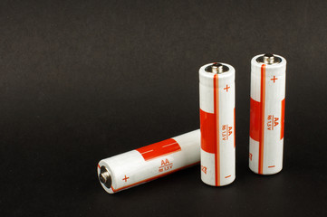 Three AA batteries isolated on the black background