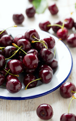 sweet cherry on a plate on wooden table