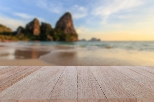 Top wooden table and blur of tropical beach background