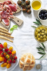 prosciutto crudo with bread, olives, tomatoes, bread sticks, oli