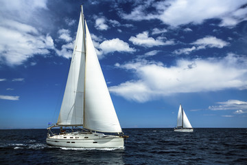 Fototapeta premium Ship yachts with white sails in the open sea. Sailing. Yachting. Luxury Lifestyle.
