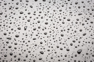 Macro water drop on black stone texture