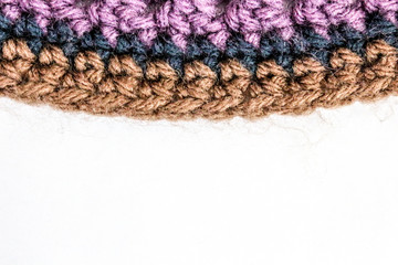 Brim of a purple, navy and brown hat