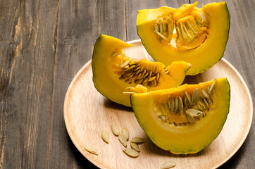 Raw pumpkin on wooden background