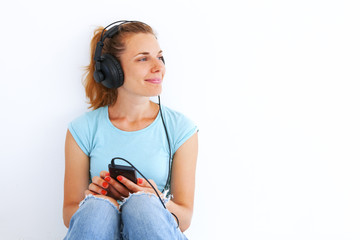 Young woman listening music with headphones.