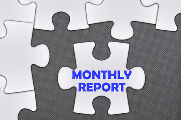 Fototapeta premium jigsaw puzzle written word monthly report