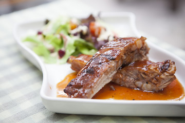 Pork rib stack with red sauce with salad