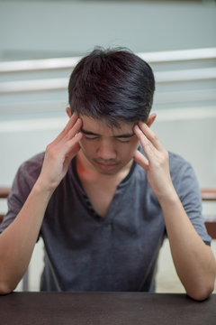 Stressed Asian young man