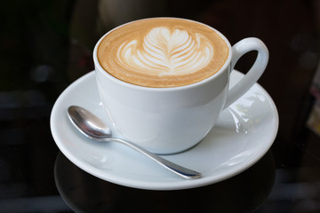 hot coffee latte, latte art with heart in a white cup