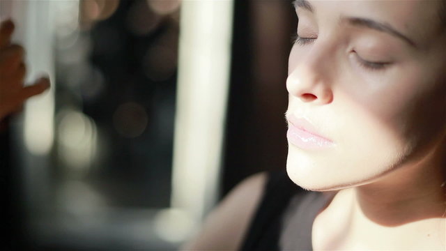 Professional make-up artist applying foundation with a brush to models face skin. Close-up