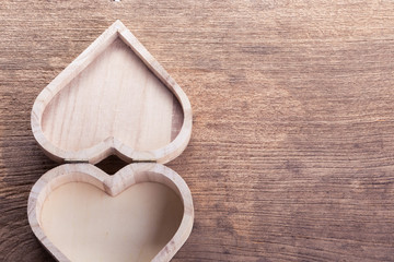 heart brown wood box on wood background, abstract love