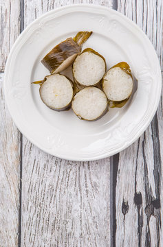 Malaysian traditional lemang dish on weathered wooden background