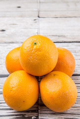 Orange fruits over weathered wooden background