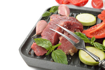 Raw steak and fresh vegetables
