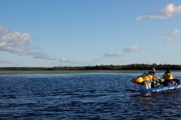 Scenic view of the Karelian lake and floating tourist kayak.