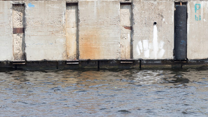 Wall of old concrete on the waterfront