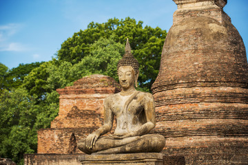 Fototapeta premium Ancient Buddha Statue at Sukhothai historical park, Mahathat Temple ,Thailand.