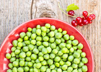 Green peas on the red plate