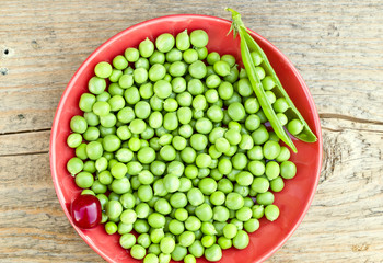 Green peas on the red plate